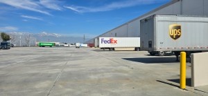 FedEx and UPS trailers at the loading dock of EOS California headquarters for outbound shipping and last-mile delivery.