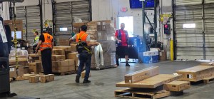 EOS staff fulfill orders at Enterprise Order Solutions LLC while Shipping Manager Marcos Velasco oversees warehouse operations.
