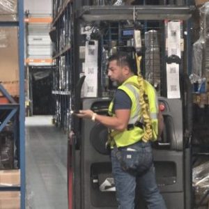 Warehouse workers use a PDA scanner to verify inventory while picking products for fulfillment.