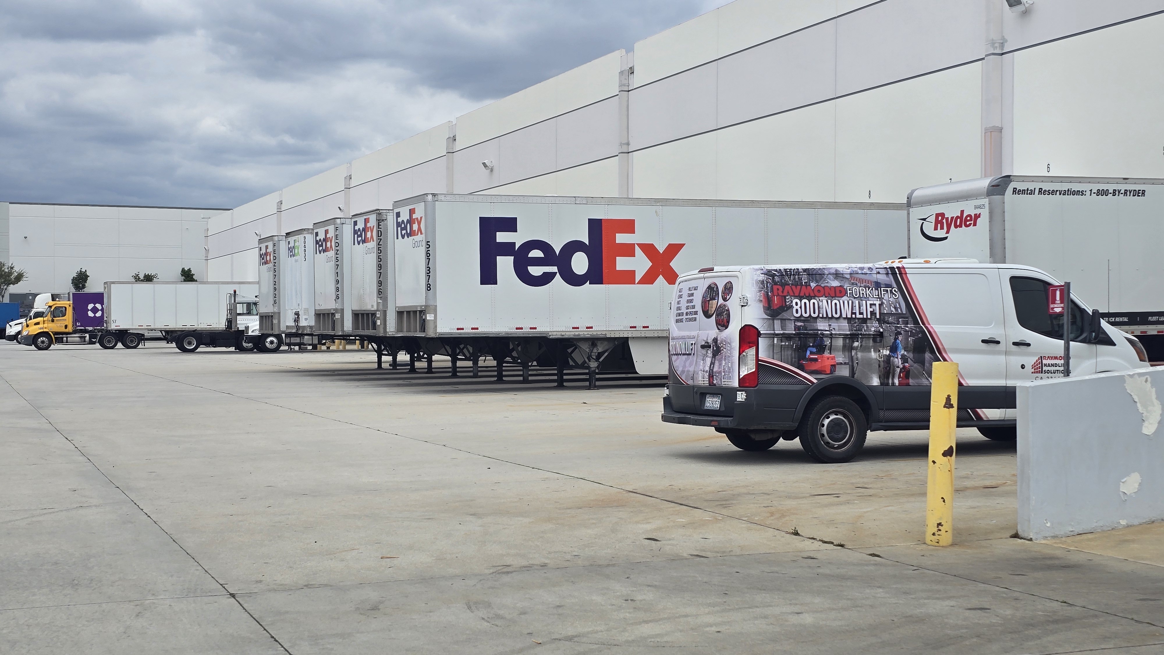 FedEx trailers and box trucks being loaded at EOS Ontario warehouse docks.